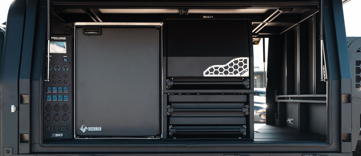 An XGO canopy open on a Ford Ranger Super Duty: the 12V panel, a fridge and the drawers