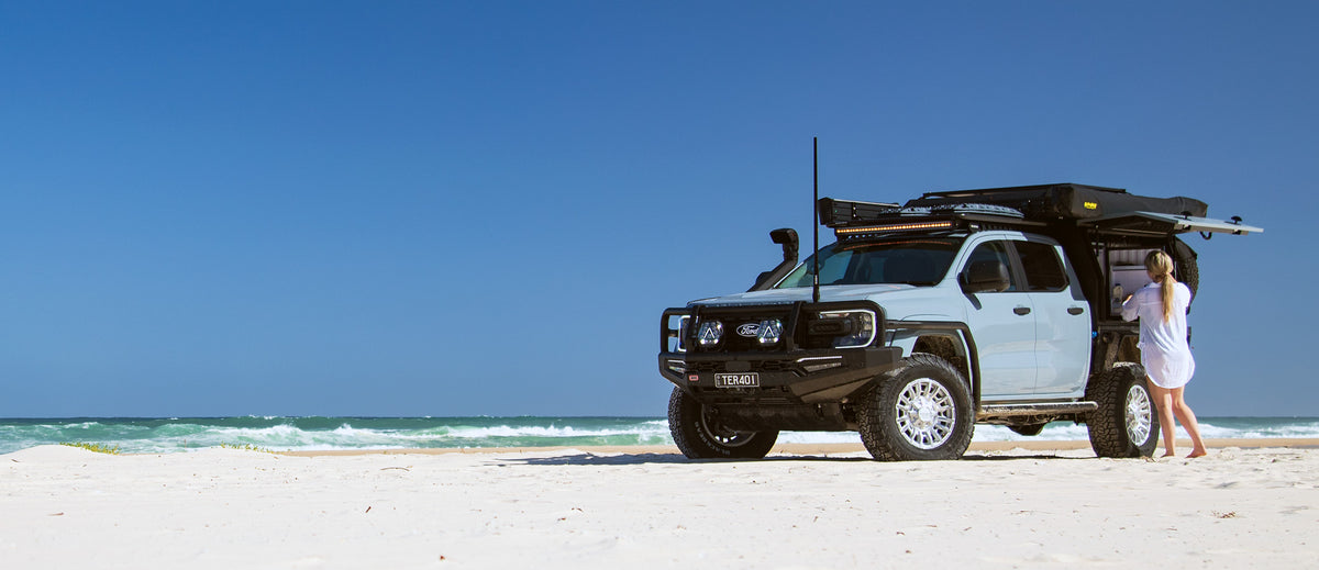 A Ford Ranger Super Duty with an XGO tray and canopy on the beach
