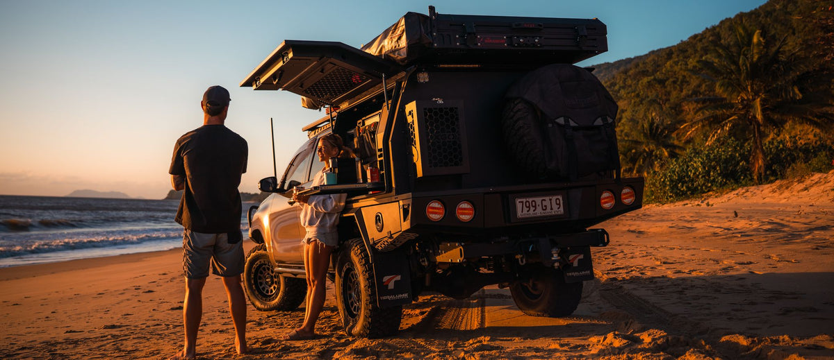 Toyota Hilux N80 with its XGO canopy open on the beach at sunset