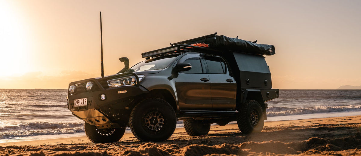 Toyota Hilux N80 with an XGO tray and canopy on the beach at sunset