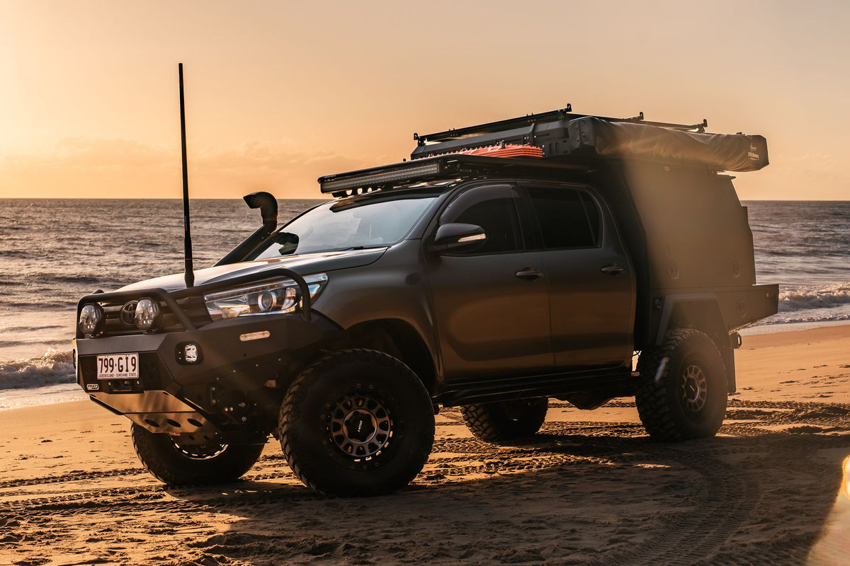 Toyota Hilux N80 with an XGO tray and canopy on the beach at sunset