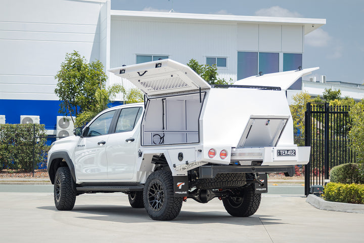 Toyota Hilux N90 with its white XGO canopy doors up, from the rear